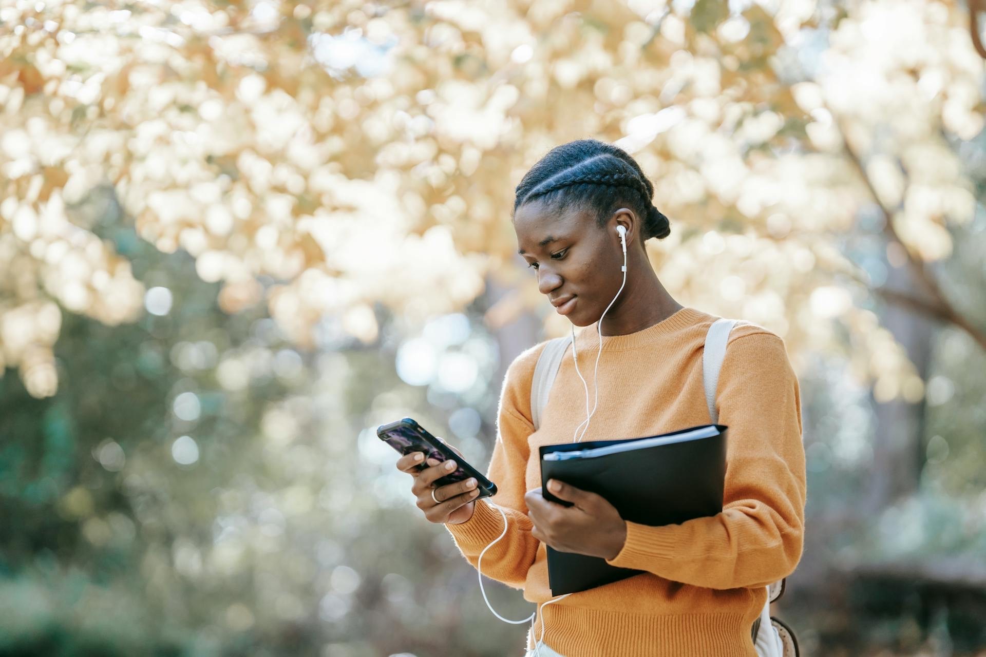 Woman Using Mobile Phone In Outdoor Setting