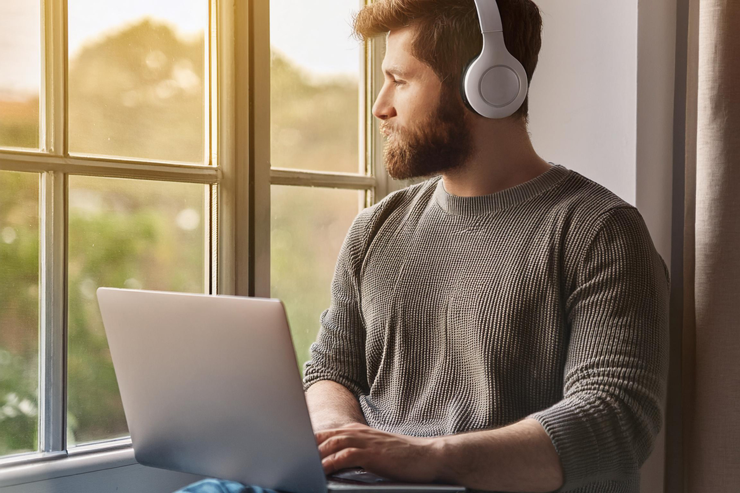 Man browsing wellbeing self-help service directory on laptop