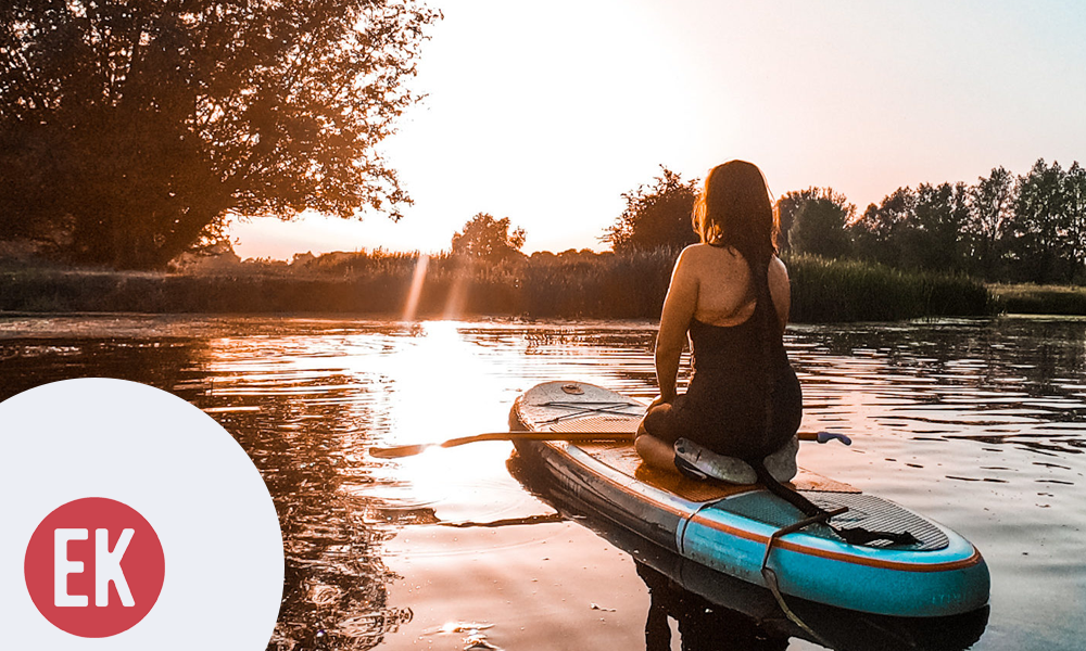 Photo of individual using kayak on river with Explore Kent logo overlay