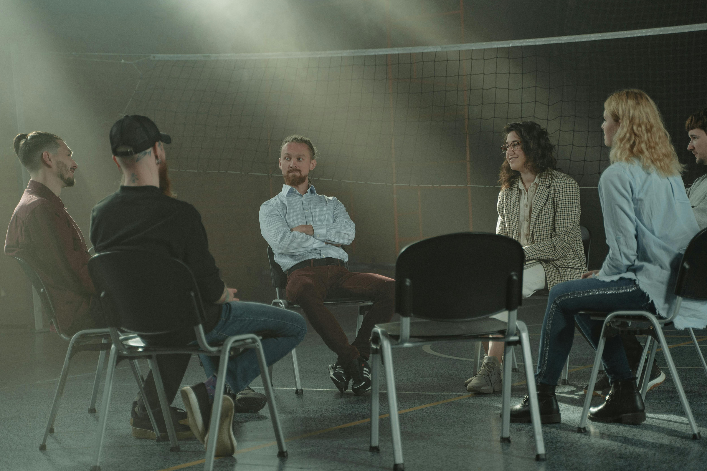 Groupwork Session Hosted By Man In Light Blue Shirt In Sports Hall