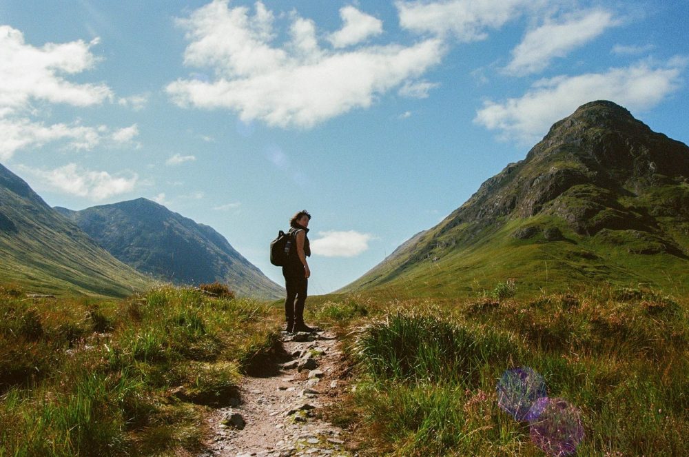 young woman kinking in the mountains in the uk