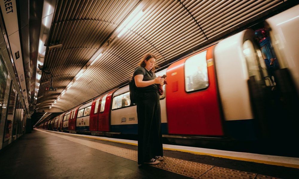 Woman Using Mobile Device On The Underground Aspect Ratio 1000 600
